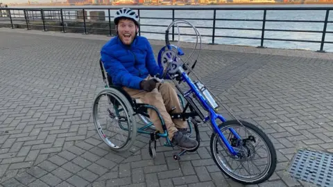 Ellis Palmer Journalist Ellis Palmer using his handcycle