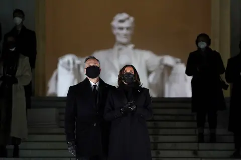 Getty Images US. Vice-President Kamala Harris and her husband Doug Emhoff attend a televised ceremony at the Lincoln Memorial on 20 January 2021 in Washington, DC.