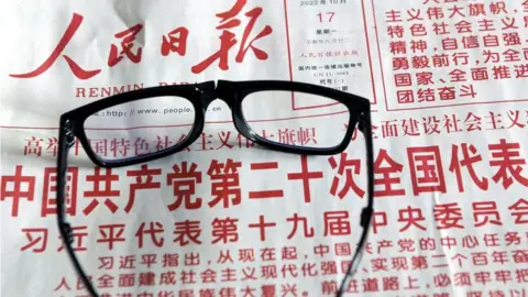 A citizen reads a newspaper to learn about the report of the 20th Communist Party of China (CPC) Congress in Shenyang, Liaoning province, China, Oct 17, 2022.