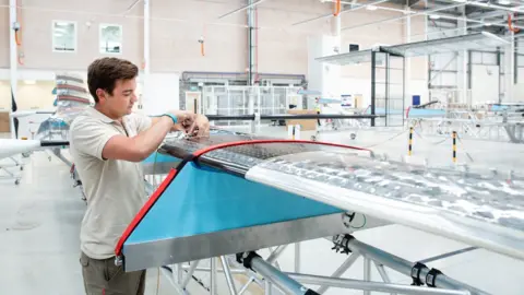 Phil Adams/Airbus An engineer works on the wing of a Zephyr