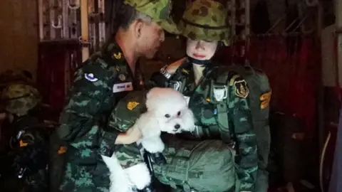 EPA Thai King Maha Vajiralongkorn (L) holding a poodle next to royal consort Sineenat Wongvajirapakdi (R)