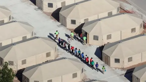Reuters Children walking between tents at the Tornillo camp in Texas