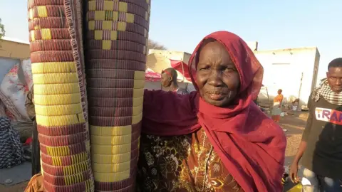 Hassan Lali/ BBC Woman holding a mat