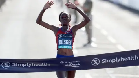 PA  Brigid Kosgei crossing the finish line