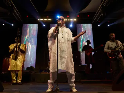 AFP Malian singer Salif Keita performs during a concert to raise awareness about the violences against albinos on November 17, 2018 in Fana, where a 5 years old albino girl has recently been murdered.