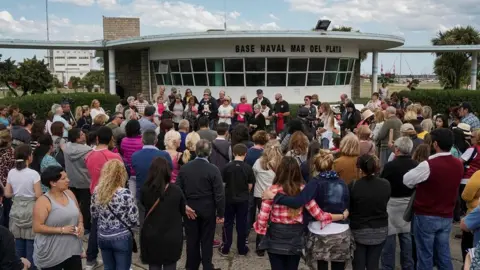 AFP/ Getty Images about 150 people outside a naval base building