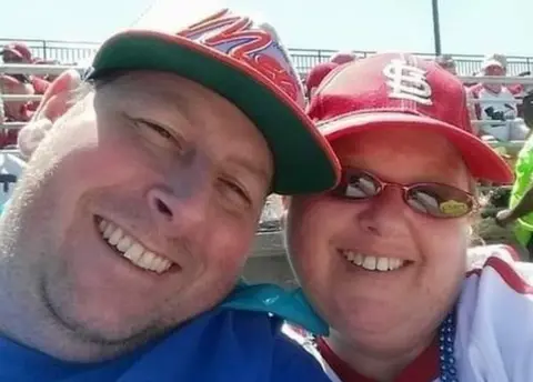 Facebook Man and woman at baseball game.