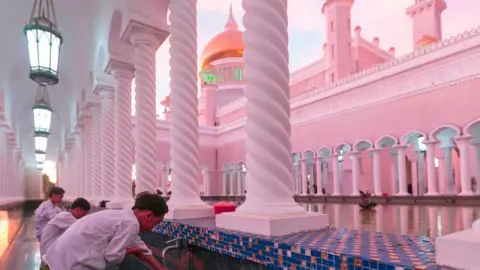 Getty Images In this picture taken on April 1 2019, children perform ablutions before praying at the Sultan Omar Ali Saifuddien mosque in Bandar Seri Begawan