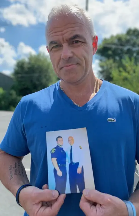 Dave Betz Dave Betz shows a photo of him and his son David.