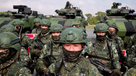 Getty Images Taiwanese soldiers take part in a demonstration showing their combat skills during a visit by Taiwan's President Tsai Ing-wen at a military base in Chiayi on 6 January , 2023.