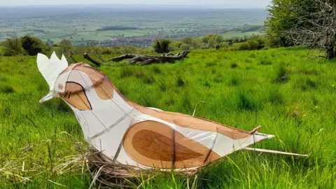 A sculpture of a skylark made from willow and paper