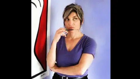 Jacob Peter Fennell  Ellen Forney posing with a paintbrush in hand