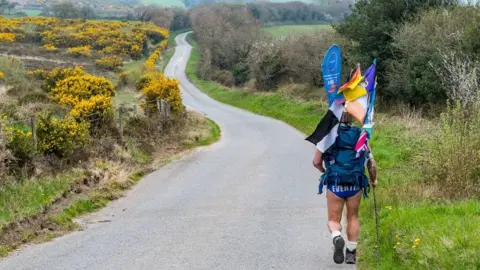 David Ellison Photography Speedo Mick walking along a road