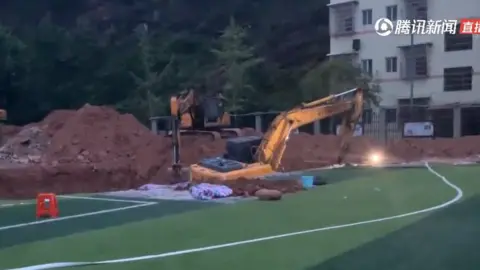 Beijing News Chinese television aired footage of investigators digging up the school's running track