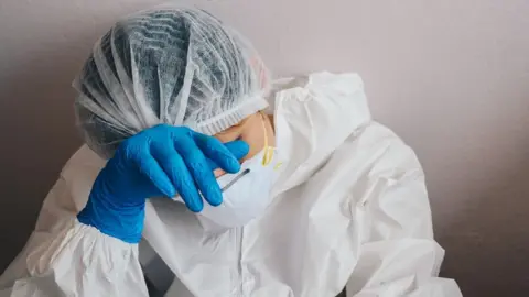 Getty Images Exhausted health worker