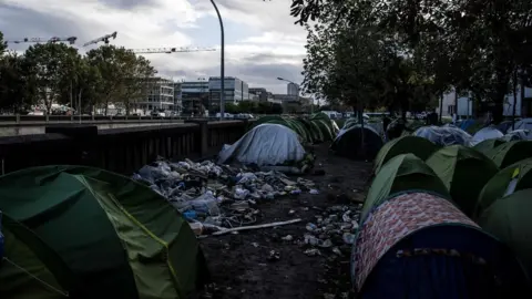 AFP Parisians have become used to seeing make-shift camps beside the ring road at Porte de la Chapelle in north-east Paris