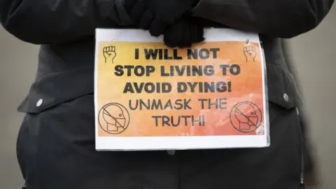 Getty Images Anti-vaccination protester in Bristol