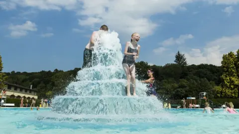 PA Children enjoy the sun at Ilkley Lido in Yorkshire