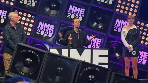 Getty Images Emily Eavis picking up the Godlike Genius award at the NME Awards