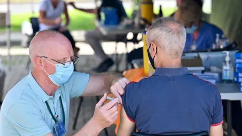 Getty Images Man receiving vaccine in Glasgow