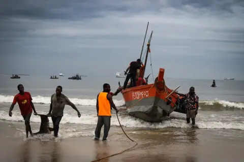 Christopher Clark Fishermen standing by their boat