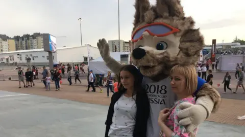 Two locals in Volgograd with World Cup mascot Zabivaka