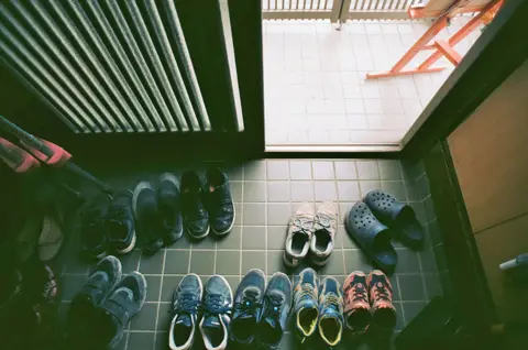 Stephane Bureau du Colombier Shoes outside the free school