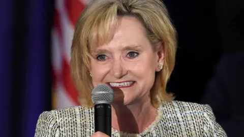 EPA Cindy Hyde-Smith holds a microphone