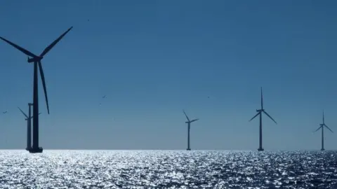 Four wind turbines at sea