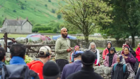 Haroon Mota A group of walkers listening to Haroon Mota