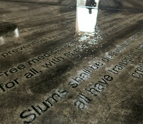 BBC/Thuthuka Zondi Ntokozo Dube reflected in the Freedom Charter monument in Kliptown, South Africa - 2024