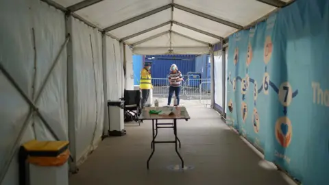 Getty Images People at a Falmouth vaccine centre