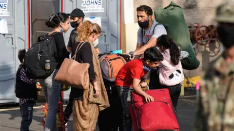 Getty Images Afghans with luggage at Dulles Expo Center, Virginia