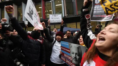 EPA Julian Assange supporters celebrate outside the Old Bailey court in central London, Britain, 04 January 2021. British media report London's Old Bailey courthouse ruled on 04 January 2021