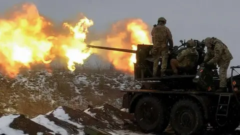 Ukrainian soldiers fire an anti-aircraft gun at a position near Bakhmut. February, 2023