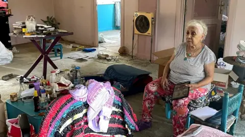 Wael Hussein/BBC Ekhlas Helmy packs her belongings on her Nile houseboat