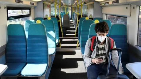 Reuters A man on a train with a mask on