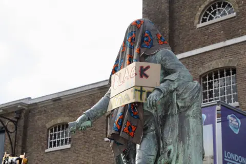 Getty Images This statue of slave owner Robert Milligan has now been removed