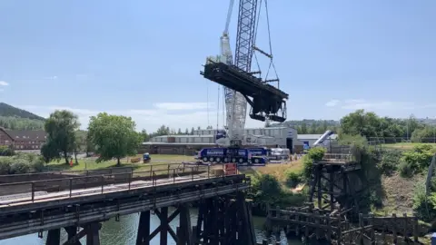 Swansea Council Crane lifts bridge section from its footings