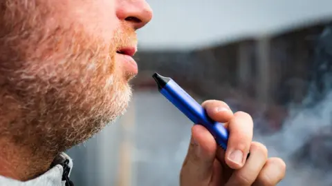 Getty Images Man smoking disposable vape