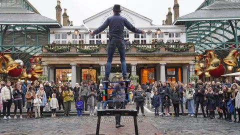PA Media A photo of a street performer