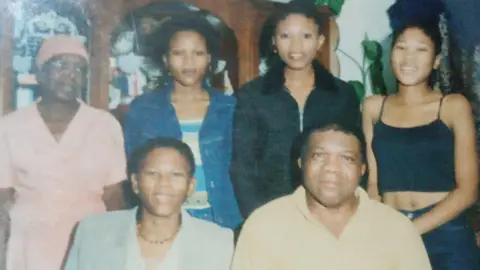 Agnes Sithole Agnes, her husband Gideon and their three daughters