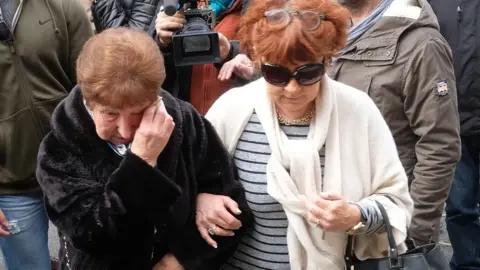 AFP Mourners arrive at the Saint Etienne church