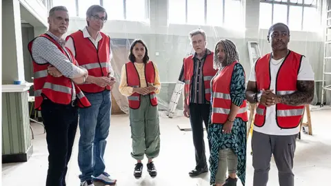 BBC/Big Talk/Four Eyes Picture shows: John (DARREN BOYD), Greg (STEPHEN MERCHANT), Rani (RHIANNE BARRETO), Frank (CHRISTOPHER WALKEN), Myrna (CLARE PERKINS), Christian (GAMBA COLE)