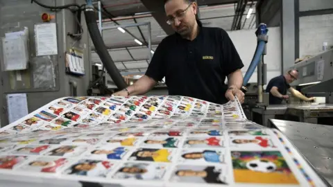 Getty Images A worker prepares sheets of stickers at the Panini factory in Italy ahead of the 2018 World Cup