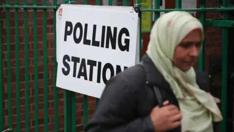Getty Images A woman outside a polling station in Ilford, east London