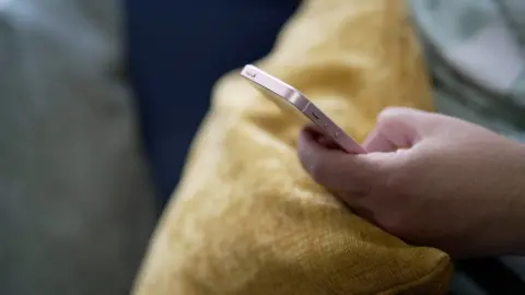 BBC Hand holding an iphone