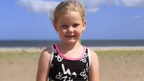 Family handout A girl smiles at the camera