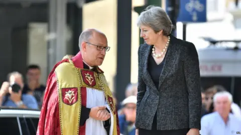 PA Prime Minister Theresa May and the Dean of Southwark Andrew Nunn