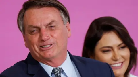 Reuters Jair Bolsonaro and his wife Michelle